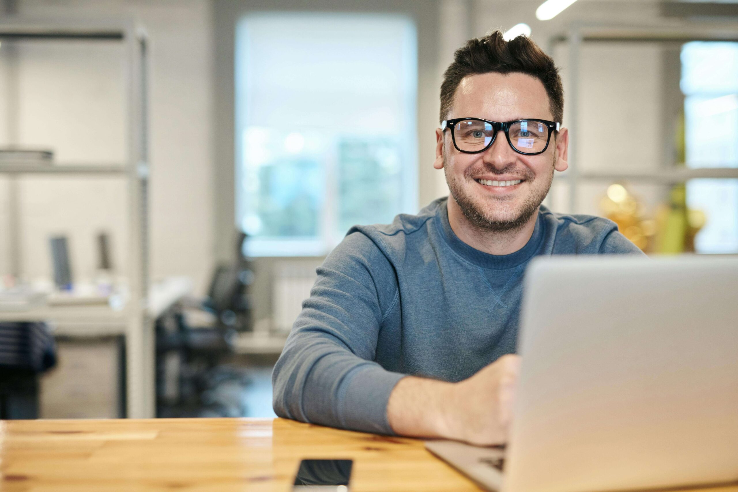 A man in front of his laptop.